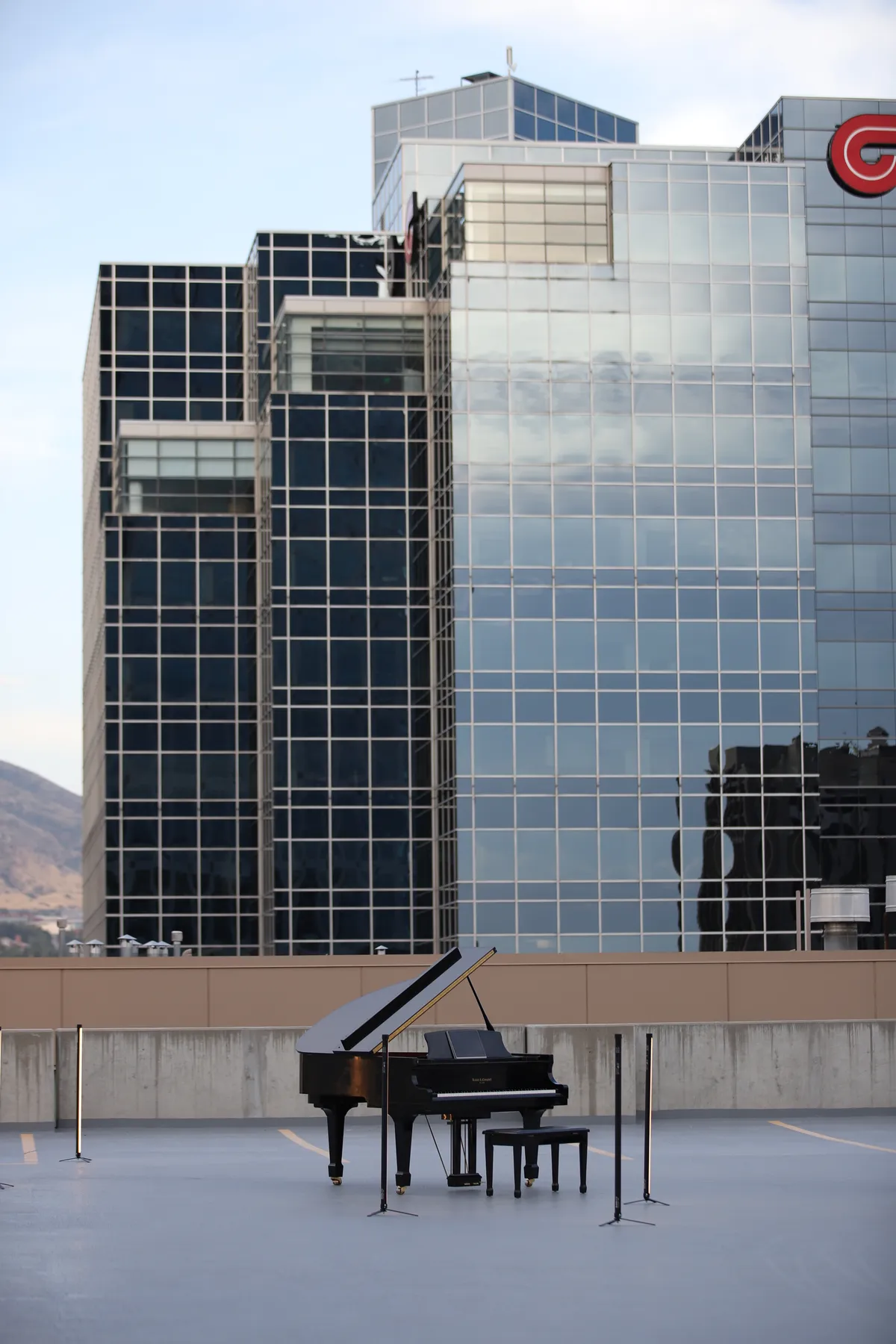 Music video shoot on the Bonneville Salt Flats: a pianist plays while a woman in a red dress and a photographer move through the frame at sunset.