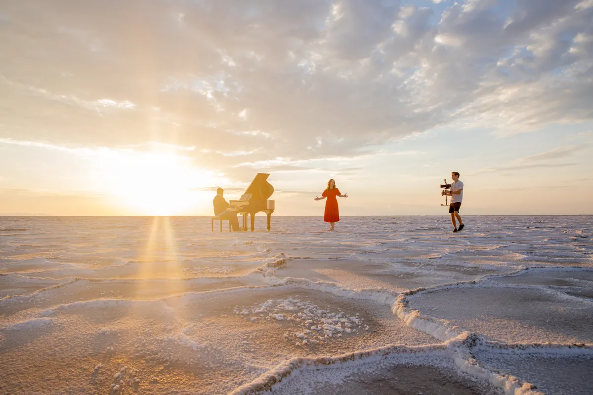 Black grand piano on the cracked salt of the Bonneville Salt Flats.