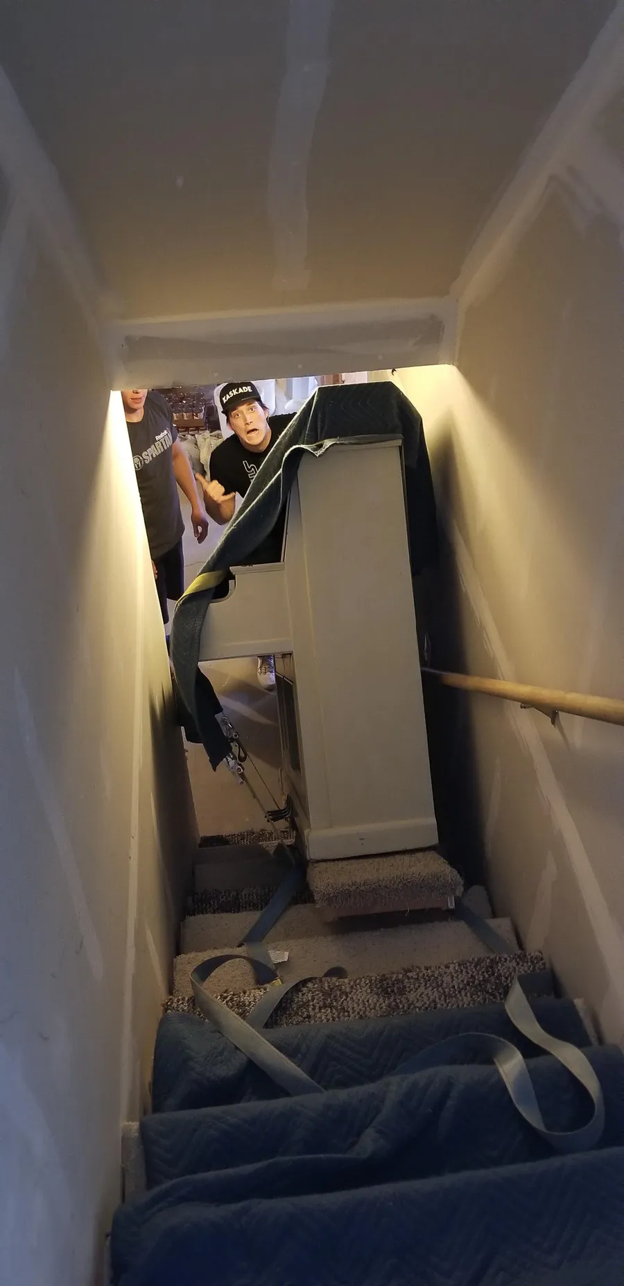 Safe and Sound Pianos crew working a piano move at a residential location.