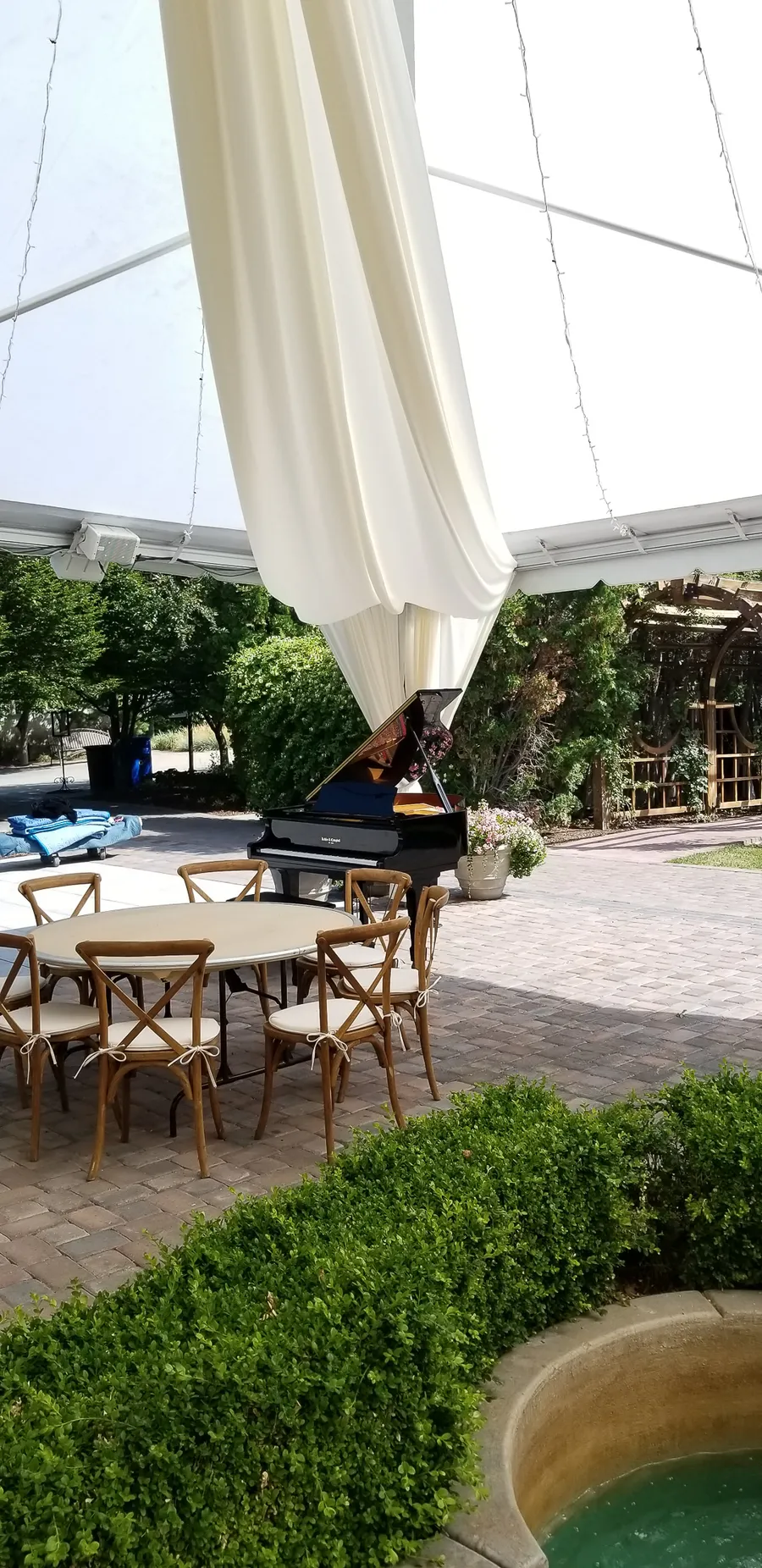Piano placement at an outdoor Utah wedding venue, crew finalizing the setup.