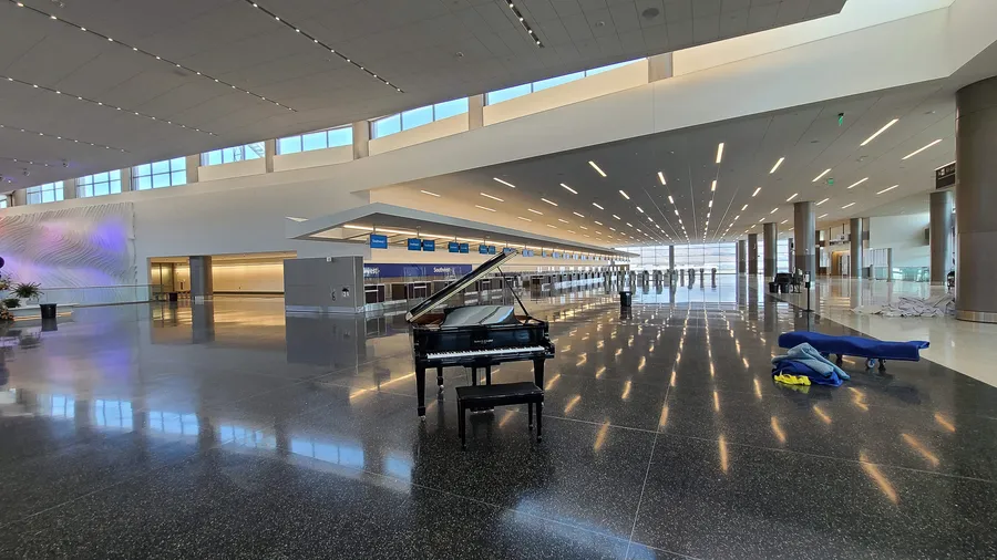 Wide view of the Salt Lake City Airport terminal during the opening day — Safe and Sound Pianos rental delivery in place.