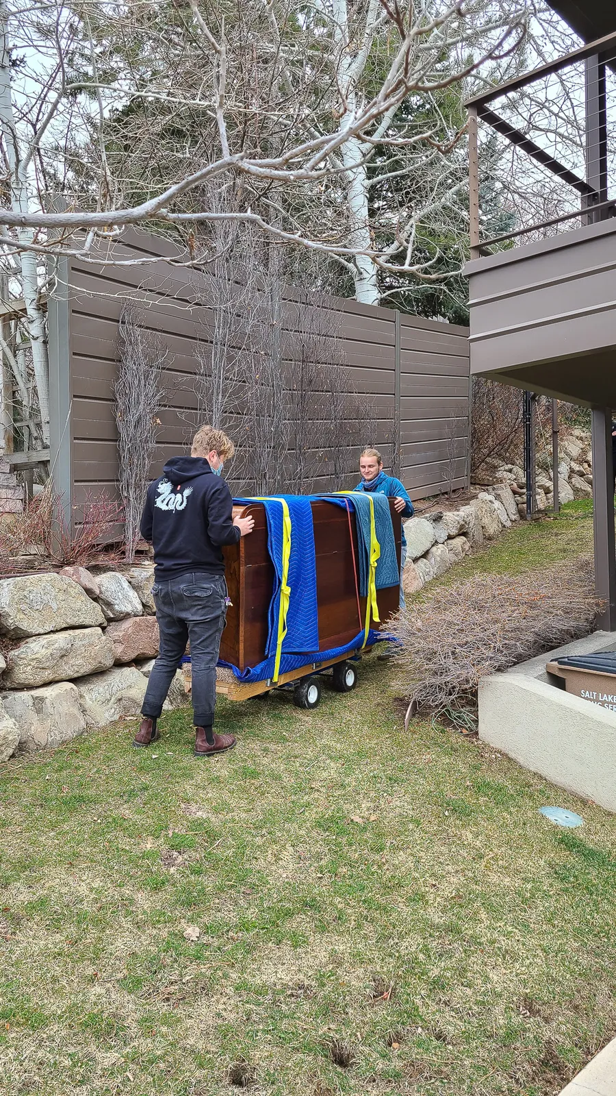 Crew member working a piano move at a Utah residence in late March 2021.