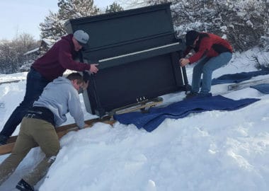 huge piano being moved across snow in bountiful utah