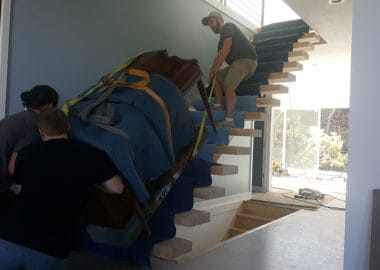 Upright piano being moved in utah by professionals